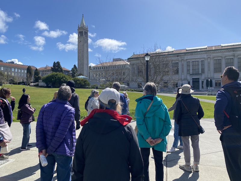 OLLI members on a campus walking tour with campanile in background
