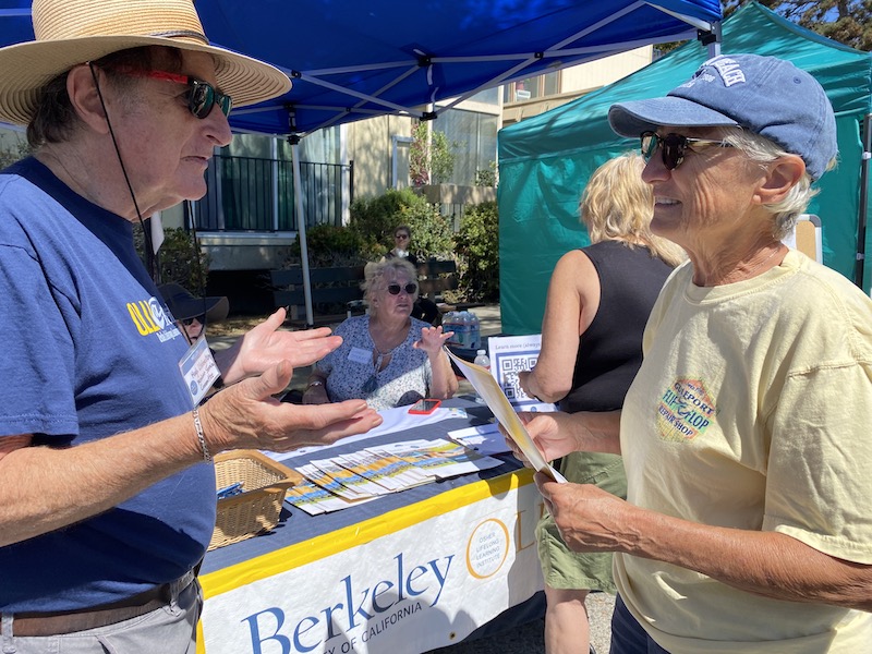 Member volunteers talking to booth visitors at Solano Stroll